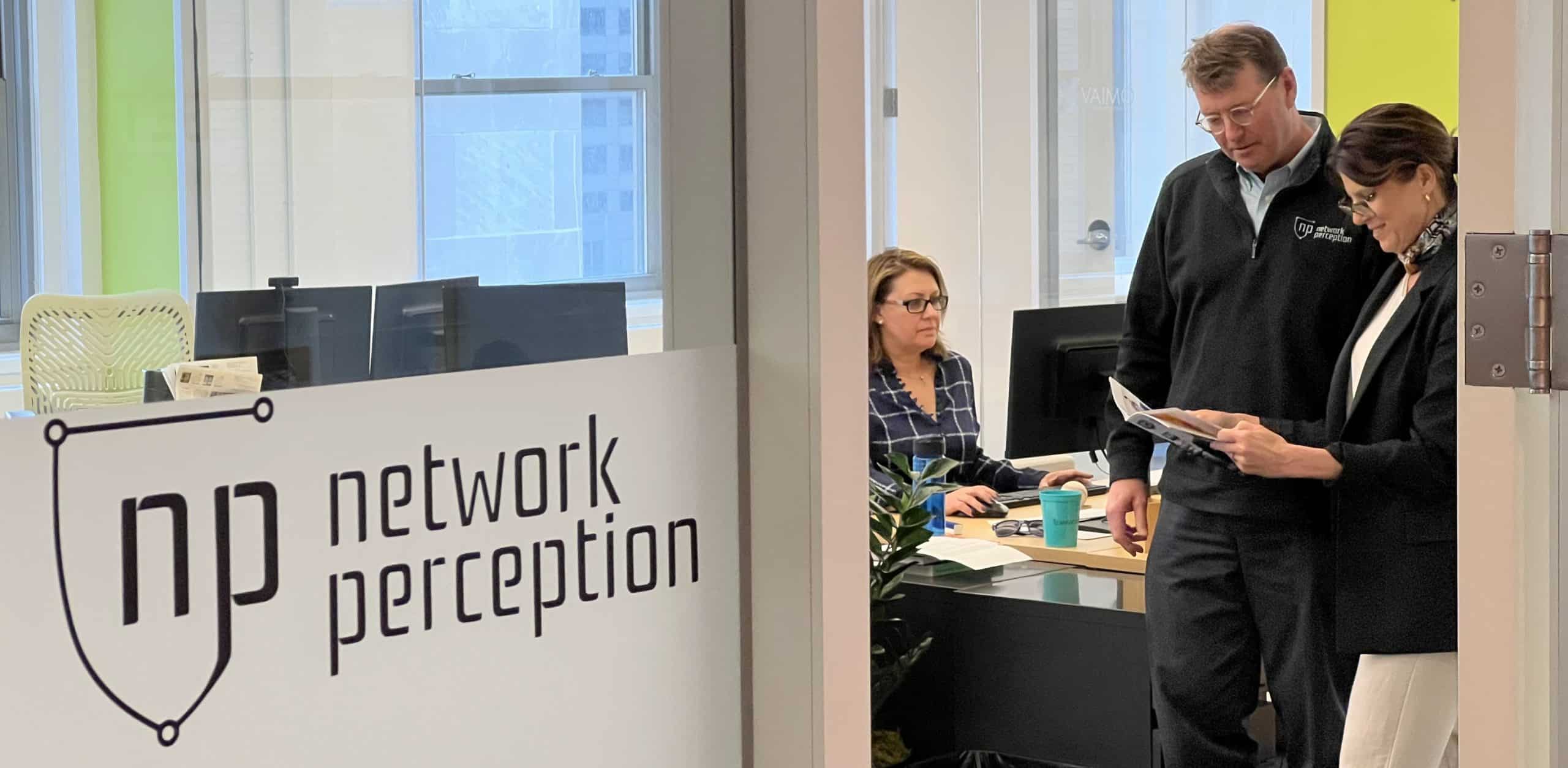 network perception employees looking at a booklet