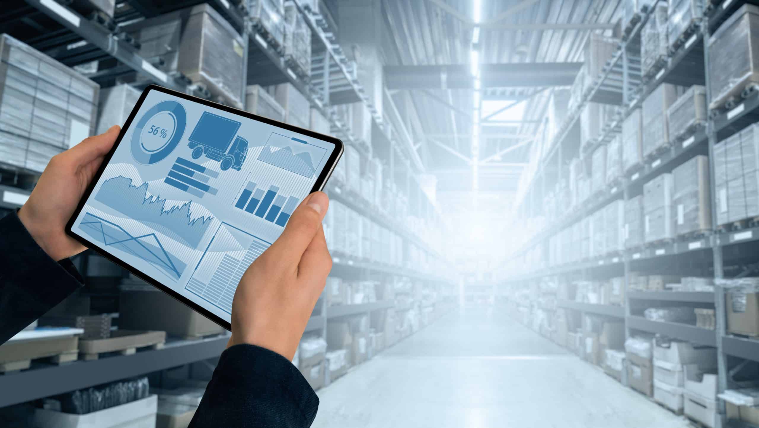 hands holding tablet in warehouse
